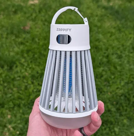 ZapShield Bug Killer by Zappify held in a hand above grass